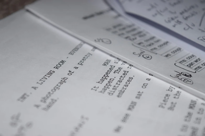 a close up of a piece of paper on a table, by Julian Allen, pexels, screenwriter, formulas, storyboarding, open book page