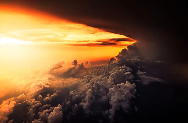 the sun is setting over the clouds in the sky, a picture, by Bernardino Mei, shutterstock, thunderstorm and fire, above view, from above, stunningly ominous