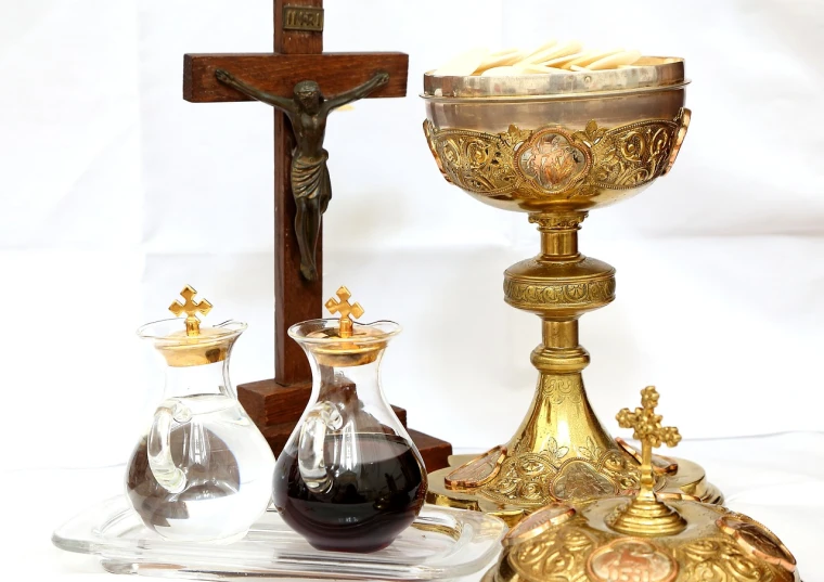 a group of religious items sitting on top of a table, baroque, liquid gold, glassware, antique style, ankh