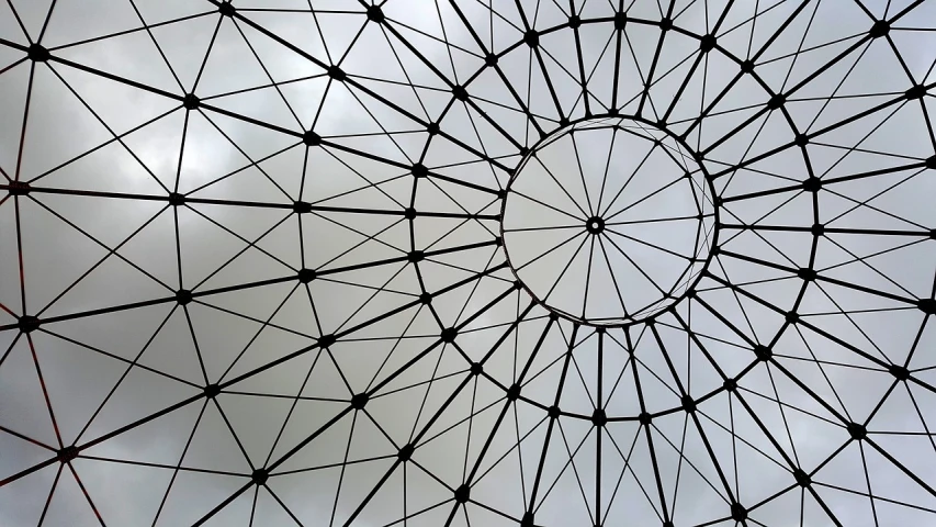 a close up of a metal structure with a sky in the background, an abstract drawing, inspired by Buckminster Fuller, pexels, circle iris detailed structure, epcot, detailed grid as background, dome