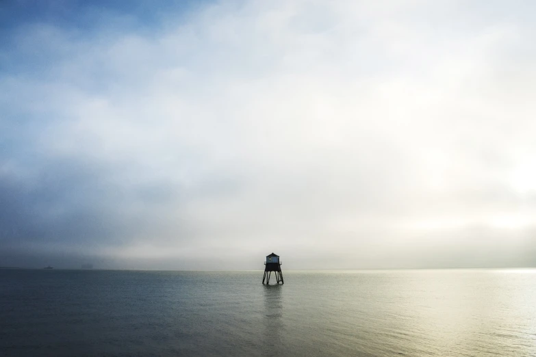 a lighthouse in the middle of a body of water, a picture, by Karl Buesgen, minimalism, maryport, water mists, watch tower, sony 14mm f2.8