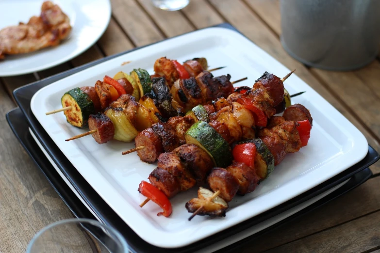 a close up of a plate of food on a table, pixabay, dau-al-set, skewer, redneck, glazed, summer vibrancy