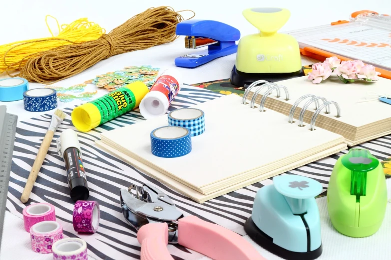 a variety of craft supplies laid out on a table, a picture, detailed », bright sky, packshot, print!