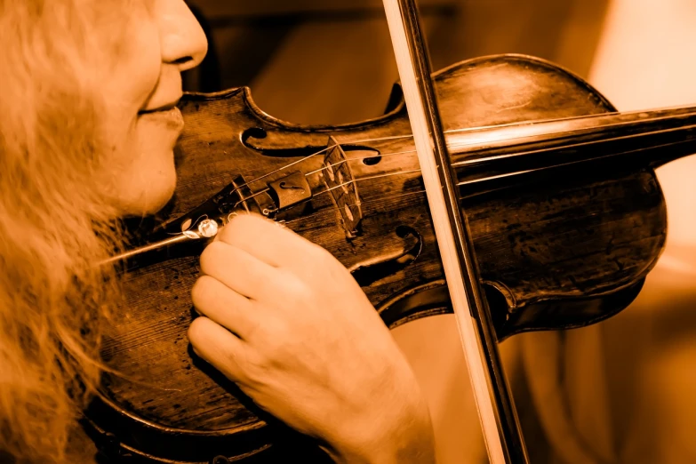 a close up of a person playing a violin, a picture, by Eugeniusz Zak, shutterstock, baroque, sepia photography, stock photo, concert photo, colorado