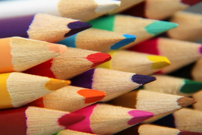 a pile of colored pencils sitting on top of each other, a macro photograph, mobile wallpaper, colorful”