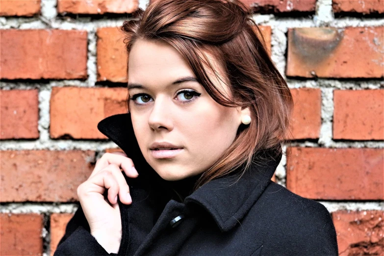 a woman standing in front of a brick wall talking on a cell phone, a photo, by Mathias Kollros, flickr, realism, gorgeous female samara weaving, mid-shot portrait of a beautiful, clara oswald, headshot profile picture