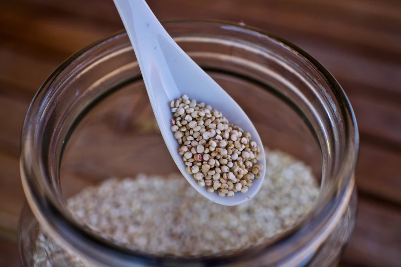 a close up of a spoon with food in it, by Dietmar Damerau, pixabay, hurufiyya, luscious with sesame seeds, inside a glass jar, heavy grain, hemp