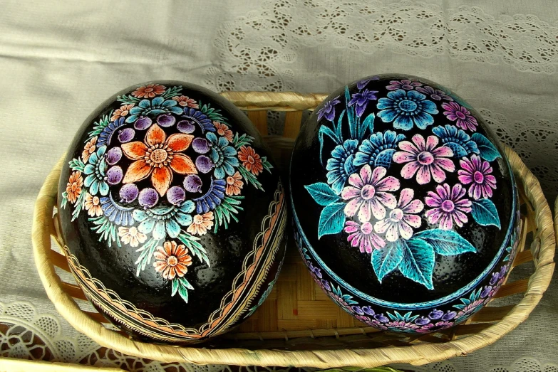 two painted eggs in a basket on a table, by Wen Boren, flickr, folk art, exquisite black accessories, flowers with intricate detail, -w 512, malaysian