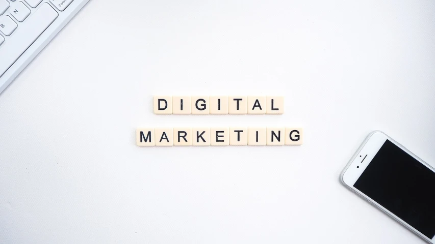a cell phone sitting on top of a desk next to a keyboard, digital marketing, in white lettering, pixelated, flatlay