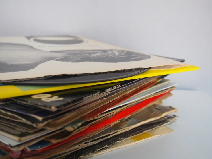 a stack of magazines sitting on top of a table, an album cover, postminimalism, photo from the 7 0 s, istock, random detail, spinning records