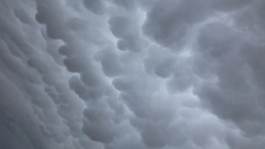 a plane is flying through a cloudy sky, a picture, by Alexander Scott, precisionism, mammatus clouds, ultrafine detail ”, looking at the ceiling, grey