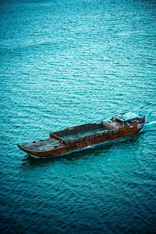 a boat in the middle of a large body of water, a stock photo, by Richard Carline, shutterstock, mingei, brown and cyan color scheme, hong kong, truck, pirates