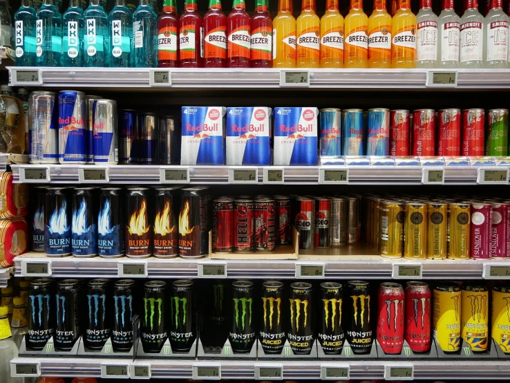 a shelf filled with lots of different types of drinks, hyperrealism, fighting stance energy, monster, photograph credit: ap, stock photo