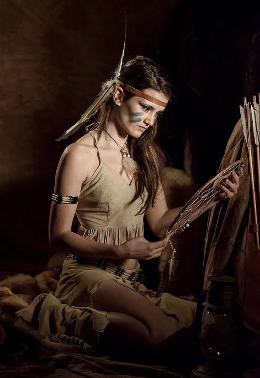 a woman dressed as a native american sitting on the ground, a cave painting, by Antoni Brodowski, renaissance, realistic cosplay, portrait of a young pocahontas, elf long weaving brown hair, photo of a model