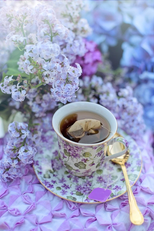 a cup of coffee sitting on top of a saucer, by Rhea Carmi, romanticism, lilacs, cottagecore!!, green tea, high quality product image”