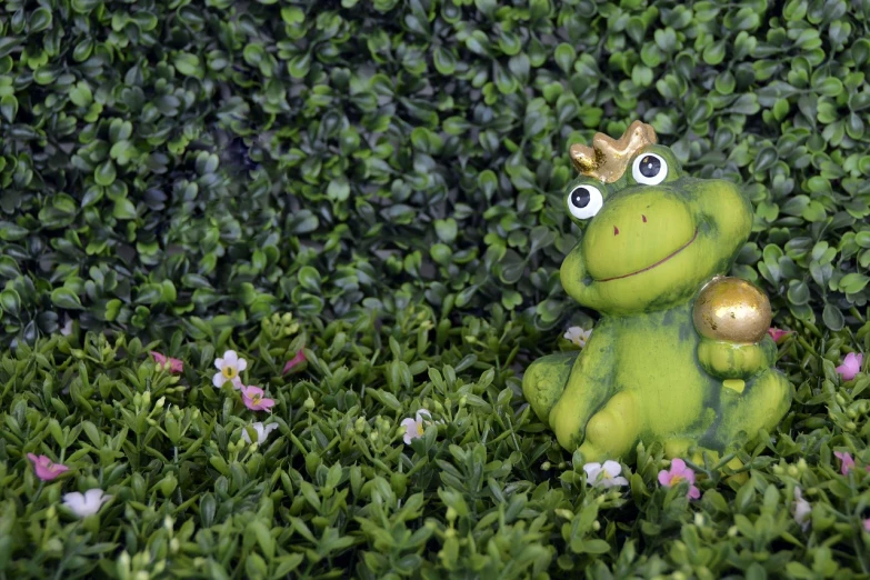 a frog that is sitting in the grass, a picture, inspired by Károly Brocky, figuration libre, clay animation, royal garden background, toy photo, prince