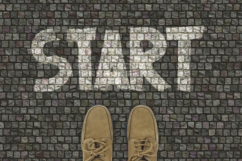 a pair of shoes standing in front of a street sign, a picture, by Kurt Roesch, trending on pixabay, stone steps, a person standing in front of a, start, work in progress