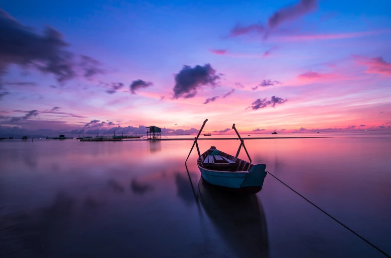 a small boat sitting on top of a body of water, a picture, by Brad Holland, pexels, blue and pink colors, sunrise colors, purple and blue and green colors, colour hd photography