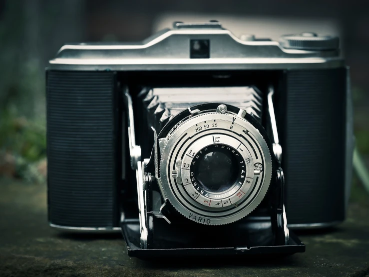 a close up of a camera on a table, inspired by Vivian Maier, flickr contest winner, art photography, dusty old ferrotype, symmetrical shot, camera shutter iris, sharp focus!