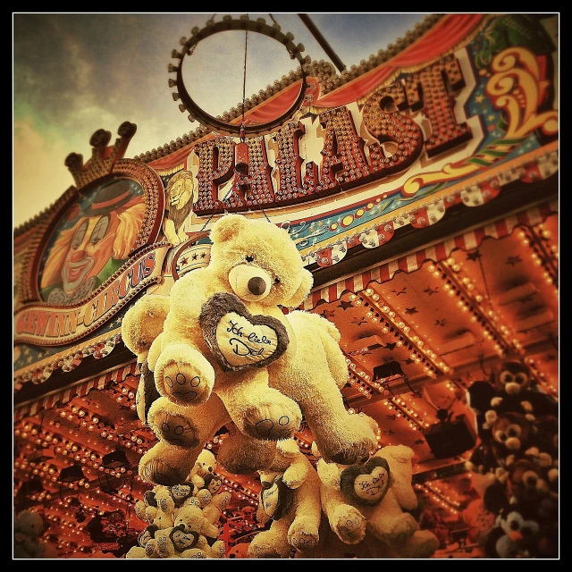 a teddy bear hanging from the ceiling of a carnival, a photo, by Edward Corbett, flickr contest winner, romanticism, iphone picture, entwined hearts and spades, cheburashka, rollercoaster