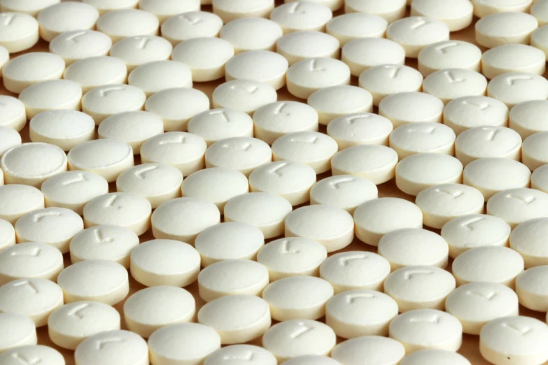 a lot of white pills sitting on top of a table, a picture, bauhaus, packshot, ultrafine detail ”