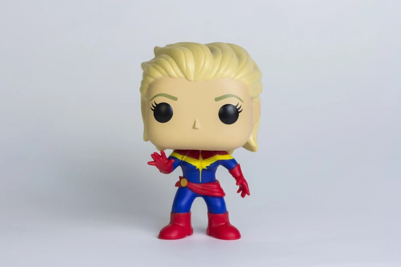 a close up of a toy on a white surface, a character portrait, captain marvel, highly detailed product photo, no gradients, product introduction photo