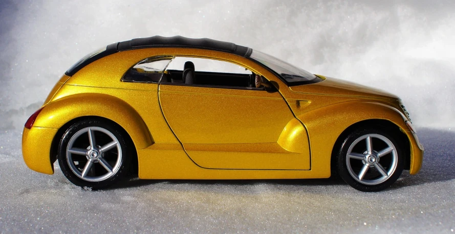 a yellow toy car sitting on top of a snow covered ground, inspired by Kentaro Miura, flickr, hyperrealism, elegant gold body, ( side ) profile, bladerunner car, [ closeup ]!!