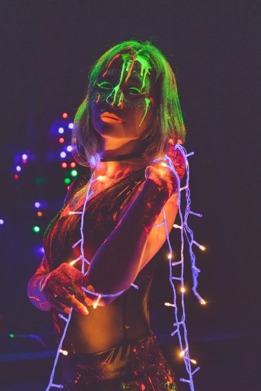 a woman standing in front of a christmas tree, cyberpunk art, inspired by Elsa Bleda, holography, good lighted photo, raver girl, dripping with color, string lights