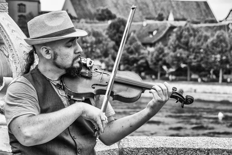 a black and white photo of a man playing a violin, by Ivana Kobilca, pixabay contest winner, at the waterside, france, patriotism, also very detailed