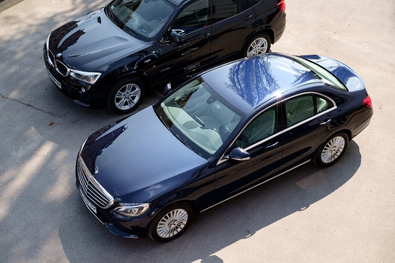 a couple of cars parked next to each other, a picture, by Alexander Bogen, shutterstock, mercedez benz, a high angle shot, shaded, ad image