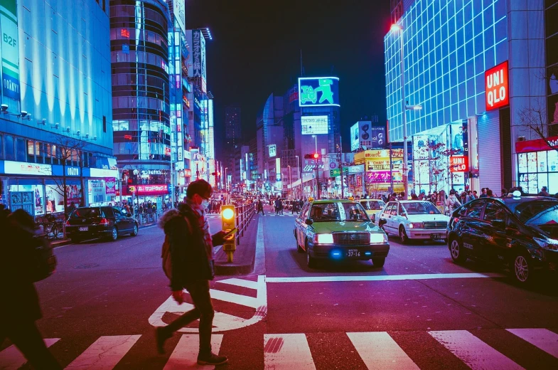 a man crossing a busy city street at night, inspired by Liam Wong, unsplash contest winner, japan 1980s, ((oversaturated)), japan travel and tourism, beautiful city of the future