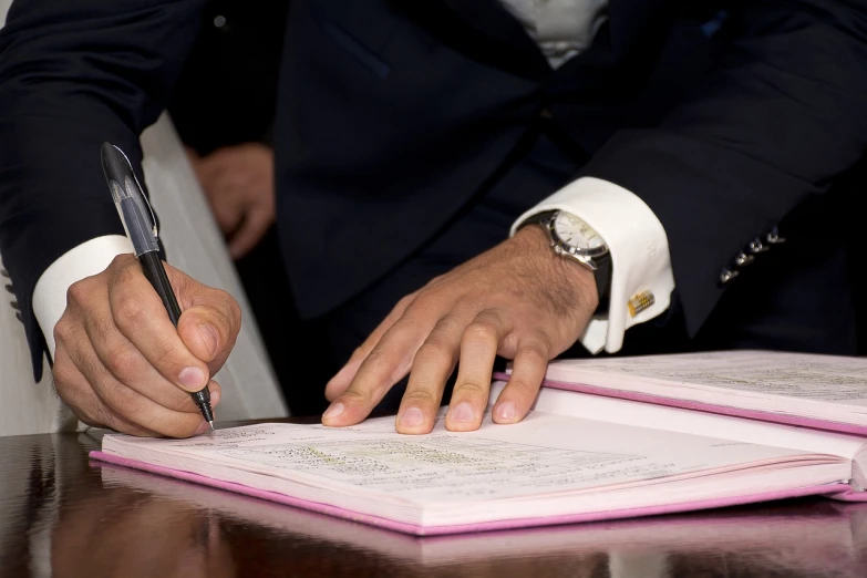 a man in a suit signing a document, by Zahari Zograf, finer details : 3, colour corrected, panel, maintenance