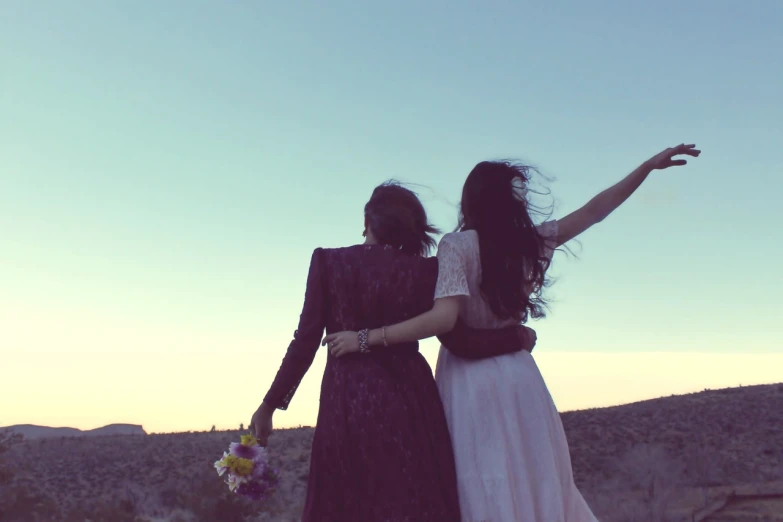 a couple of women standing next to each other, tumblr, romanticism, music video, wedding, indie film, jumping towards viewer