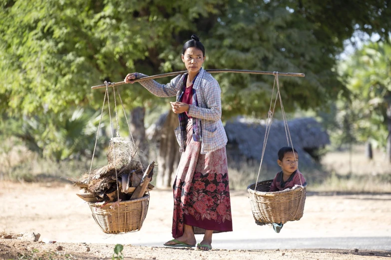 a woman carrying two baskets with animals on them, a portrait, by Richard Carline, flickr, myanmar, stock photo, son, on stilts