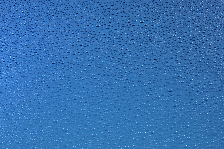 a close up of water droplets on a blue surface, a stock photo, minimalism, cloudless sky, wallpaper for monitor, very accurate photo, high details photo