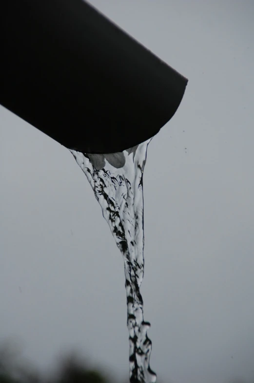 a close up of water pouring from a pipe, a photo, plasticien, 3/4 view from below, uploaded, filling the frame, portlet photo