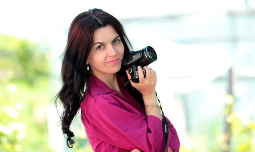 a woman in a pink shirt holding a camera, by Maksimilijan Vanka, ukrainian girl, professional profile picture, diane ramic, avatar image