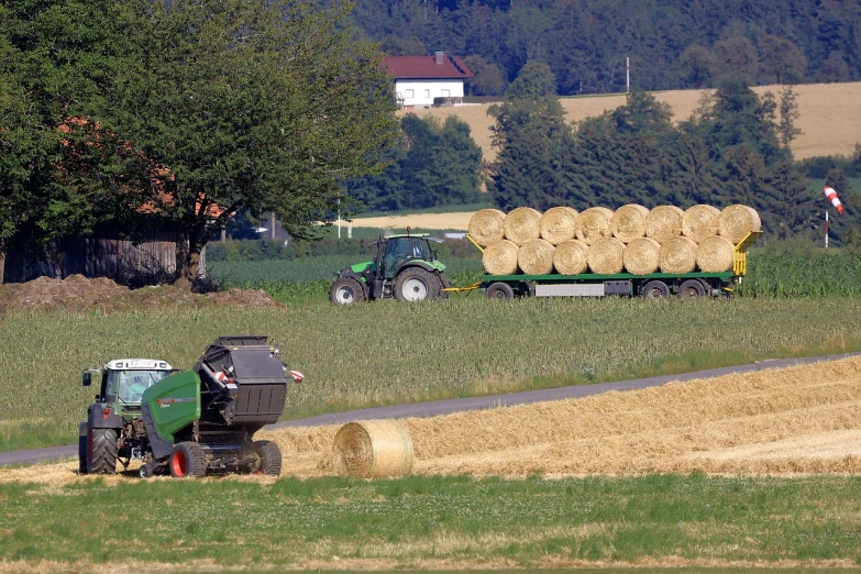 a tractor pulling a trailer full of hay, a picture, by Hans Schwarz, flickr, viewed from very far away, stockphoto, ball, maintenance photo