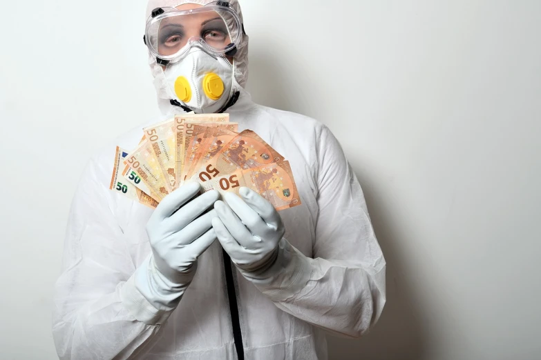 a man in a gas mask holding a bunch of money, a stock photo, by Matija Jama, shutterstock, wearing a labcoat, sao paulo, wearing gloves, rna bioweapon