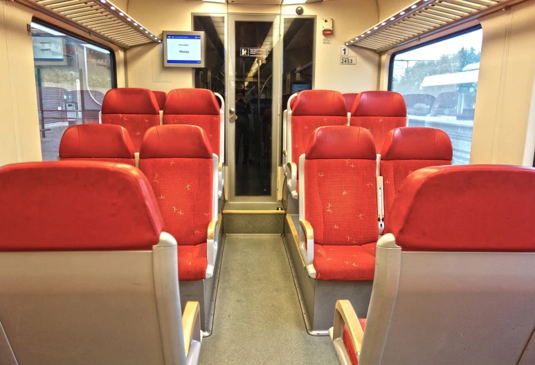 the inside of a train with red seats, flickr, renaissance, photo taken with an iphone, no gradients, elegant interior, yard