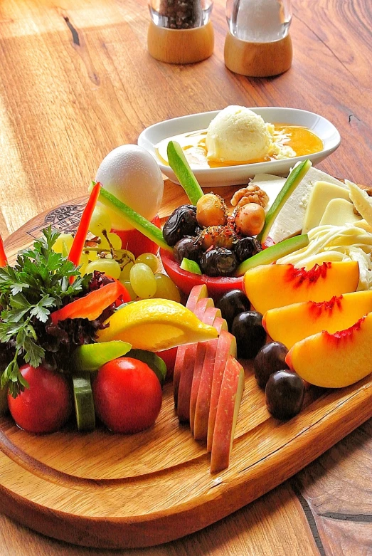 a close up of a plate of food on a table, by Franz Hegi, pexels, (a bowl of fruit)!!!!!!!!!, eating a cheese platter, vivid colors!!, on a wooden tray