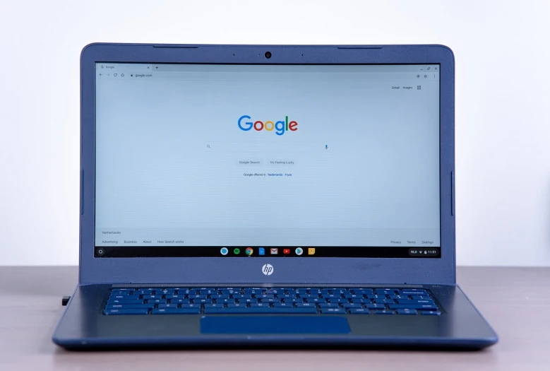 a laptop computer sitting on top of a wooden table, by Judith Gutierrez, pexels, google logo, blue themed, full front view, listing image