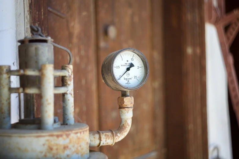 a close up of a gauge on the side of a building, a portrait, industrial rusty pipes, tabernacle deep focus, maintenance photo