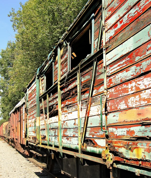 a train traveling down train tracks next to a forest, by Richard Carline, flickr, auto-destructive art, rusted panels, shack close up, under repairs, old wooden ship