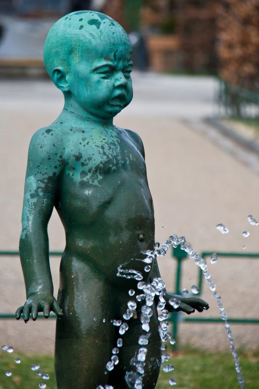 a statue of a baby with water coming out of it's mouth, by Aurél Bernáth, stockholm, cute boy, disrobed, verdigris