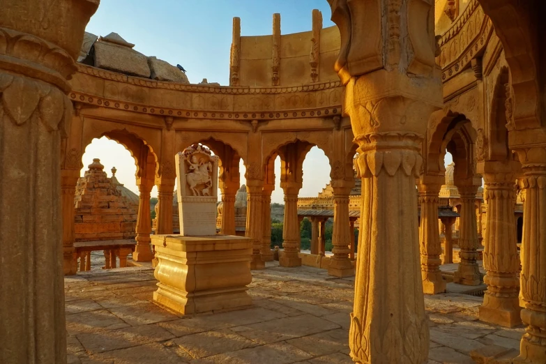 there is a statue in the middle of a building, by Joseph Henderson, pexels contest winner, samikshavad, desert temple, summer morning light, castles and temple details, arches adorned pillars