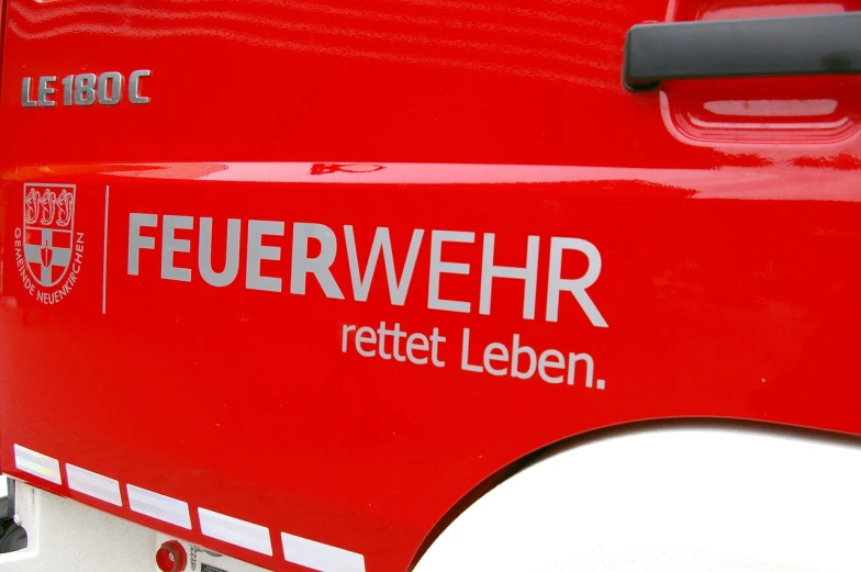 a close up of a red fire truck, by Helmut Federle, flickr, logotype design, laser, hr geiger design, soccer players timo werner