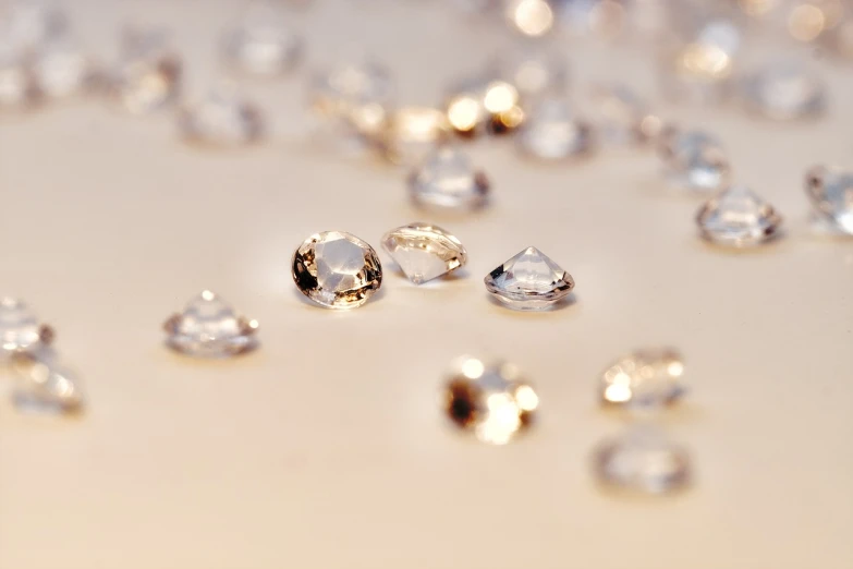 a bunch of diamonds sitting on top of a table, a macro photograph, by Rhea Carmi, high detail product photo, drops are falling from above, detailed product photo, beautiful natural soft light