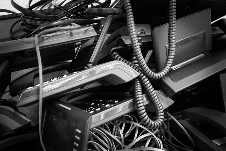 a black and white photo of a bunch of electronics, by Matija Jama, thick cables whipping around, waste, 15081959 21121991 01012000 4k, hoses:10