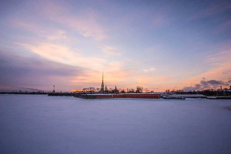 a snow covered field with a clock tower in the distance, a picture, by Sebastian Spreng, saint petersburg, sunset panorama, 1 8 mm wide shot, cathedral in the background